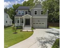 Charming two-story home featuring a covered porch, two-car garage, and a well-manicured lawn at 20 Scotland Dr, Youngsville, NC 27596