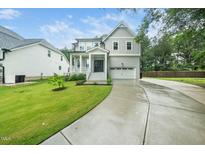 Charming two-story home with a gray exterior, landscaped yard, and attached two-car garage at 20 Scotland Dr, Youngsville, NC 27596