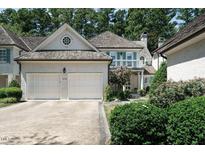 Charming home featuring a two-car garage, balcony, dormer windows, and manicured landscaping at 203 Edinburgh Dr # B, Cary, NC 27511