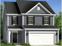 Two-story home boasts a welcoming facade, a two-car garage, classic shutters, and manicured landscaping at 221 Steel Springs Ln # 23, Angier, NC 27501