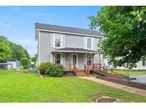 Charming two-story home with a covered front porch and handicap access ramp at 2527 Ossipee Front St, Elon, NC 27244