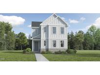 Charming two-story home with white siding, stone accents, and a well-manicured front lawn, ideal for a growing Gathering at 2924 Ocean Sunrise Dr, Wake Forest, NC 27587