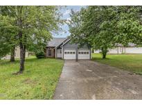 Charming two-story home with a two-car garage, and a landscaped front yard at 3306 Woodland Park Rd, Durham, NC 27703
