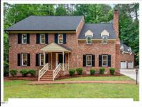Charming two-story brick home with a well-manicured lawn and inviting front porch at 45 Birnham Ln, Durham, NC 27707