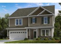 Charming two-story home with a two car garage, neutral siding, and inviting curb appeal at 519 Claftin St, Sanford, NC 27330