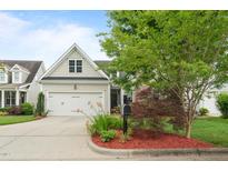 Charming home featuring a well-maintained front yard and a two-car garage at 5233 Greymoss Ln, Apex, NC 27539