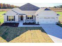 Charming single-Gathering home with a well-manicured lawn and attached two-car garage at 61 Merrifield Ln, Garner, NC 27529