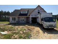 Charming two-story new home with classic architectural details awaiting finishing touches at 82 Laramie Ln, Selma, NC 27576
