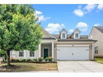 Charming single-Gathering home featuring a well-manicured lawn, two-car garage, and inviting curb appeal at 826 Downfield Ln, Fuquay Varina, NC 27526