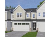 Charming townhome featuring a two-car garage, neutral siding and a welcoming entrance at 8935 Kennebec Crossing Dr # 57, Angier, NC 27501