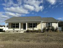 Charming single-story home with neutral siding, classic black shutters and inviting covered porch at 103 Hampshire Pl, Kenly, NC 27542