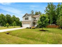 Charming two-story home with manicured lawn, attached garage and beautiful landscaping at 150 Teal Dr, Youngsville, NC 27596