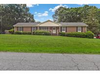 Charming brick ranch-style home with well-manicured lawn and mature trees at 2423 Northern Bnd, Burlington, NC 27217