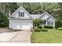 Charming single-Gathering home with an attached garage, lush landscaping, and a well-manicured lawn at 25 Spicetree Ct, Youngsville, NC 27596