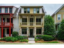 Charming two-story home with a covered front porch and stone accents and mature landscaping at 253 Tobacco Farm Way, Chapel Hill, NC 27516
