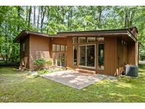 A modern house featuring a patio and surrounded by dense woodland trees at 2706 Montgomery St, Durham, NC 27705