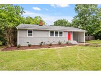 Charming single story home featuring a well-manicured lawn and inviting red front door at 3325 Old Buffaloe Rd, Raleigh, NC 27604