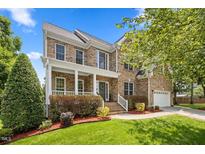Beautiful brick home with manicured lawn and covered front porch with white columns at 4 Pickard Pl, Durham, NC 27703