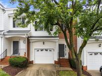 Charming townhouse with brick accents, featuring an attached garage and inviting front entrance at 5506 Cottonrose Ln, Raleigh, NC 27606