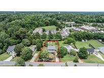 This aerial view showcases the property's location, yard, and surrounding community amenities at 601 Country Ln, Holly Springs, NC 27540