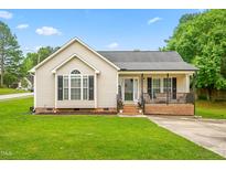 Charming single-story home with a welcoming front porch, green lawn, and classic siding at 601 Southampton Dr, Knightdale, NC 27545