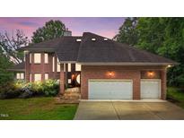 Stunning brick home showcasing a two-car garage and well-manicured landscaping at 7918 Dairy Ridge Rd, Mebane, NC 27302