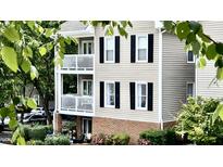 Exterior of the home with balconies, black shutters, and landscaped gardens at 923 Springfork Dr, Cary, NC 27513