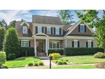 Charming two-story home featuring manicured landscaping, a welcoming porch, and classic architectural details at 101 Synandra Ln, Holly Springs, NC 27540