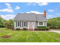 Charming single-story home with manicured lawn and mature landscaping creates a welcoming curb appeal at 1228 Shakentown St, Knightdale, NC 27545