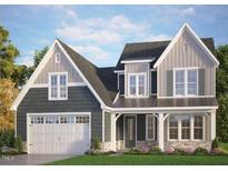 Charming two-story home featuring a two-car garage, inviting front porch, and beautiful architectural details at 153 E Victoria Ridge Dr # 11, Selma, NC 27576