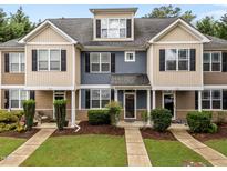 Charming townhome exterior with well-maintained landscaping and inviting front entrances at 158 Pineland Cir, Raleigh, NC 27606