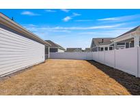 Spacious fenced backyard, perfect for outdoor activities and entertaining under a bright blue sky at 1727 Pinecliff Ct, Fuquay Varina, NC 27526