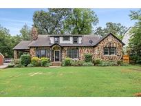 Charming stone home with a well-maintained lawn, mature trees, and inviting curb appeal at 205 Forest Hill Ave, Rocky Mount, NC 27804