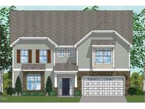 Charming two-story home with stone accents, attached garage, and well-manicured lawn and professional landscaping at 221 N Maple Walk Walk # 221, Garner, NC 27529