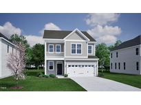 Charming two-story home featuring gray siding, white trim, a balcony, and an attached two-car garage at 263 Meadowbark Bnd # 33, Garner, NC 27529