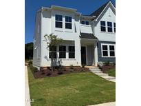 Attractive two-story home with modern design, complemented by a well-manicured lawn and landscaping at 611 Callan View Ave, Wake Forest, NC 27587