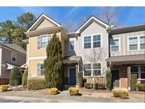 Charming townhome featuring varied siding, manicured shrubs, and a welcoming entrance, perfect for comfortable living at 684 Wickham Ridge Rd, Apex, NC 27539