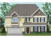 Charming two-story home featuring a welcoming porch and a two-car garage, nestled among lush trees at 74 Black Walnut Dr # 199, Garner, NC 27529