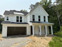 New two-story home featuring white siding, a covered front porch, and an attached two-car garage at 9197 Dupree Meadow Dr # 20, Angier, NC 27501