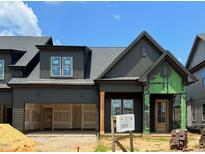 Modern two-story home with a two-car garage and a welcoming front porch is under construction at 1027 Coldspring Circle, Durham, NC 27705
