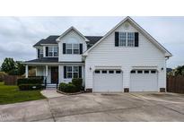 Charming two-story home with a two-car garage and well-maintained landscaping at 1100 Open Field Dr, Garner, NC 27529