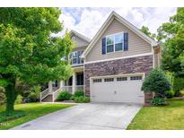 Charming two-story home with stone accents, a two-car garage, and beautifully landscaped front yard at 112 Briarfield Dr, Apex, NC 27502
