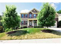 Charming two-story home with a well-manicured lawn, mature trees and a welcoming front porch at 112 Briarfield Dr, Apex, NC 27502