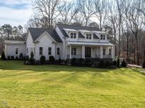 Charming two-story home with a covered porch and well-manicured lawn at 1680 Terry Road, Durham, NC 27712