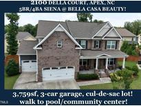 Charming brick-front home featuring a three-car garage and covered front porch in a desirable neighborhood at 2100 Della Ct, Apex, NC 27502