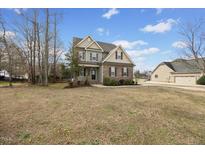 Charming two-story home with a combination of stone and siding, complemented by a well-manicured lawn and inviting curb appeal at 224 Swann Trl, Clayton, NC 27527