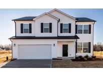 Charming two-story home featuring a white exterior, black shutters, and an attached two-car garage at 285 Johnson Ridge Way, Four Oaks, NC 27524