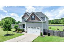 Charming two-story home featuring a two-car garage, landscaped yard and a covered front porch at 33 Northlodge Ct, Wendell, NC 27591