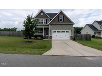 Charming two-story home featuring a two-car garage, well-maintained lawn, and inviting curb appeal at 33 Northlodge Ct, Wendell, NC 27591