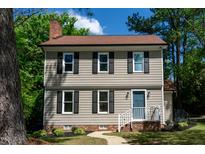 Charming two-story home with light siding, black shutters, blue door, and well-maintained landscaping at 3317 E Jameson Rd, Raleigh, NC 27604